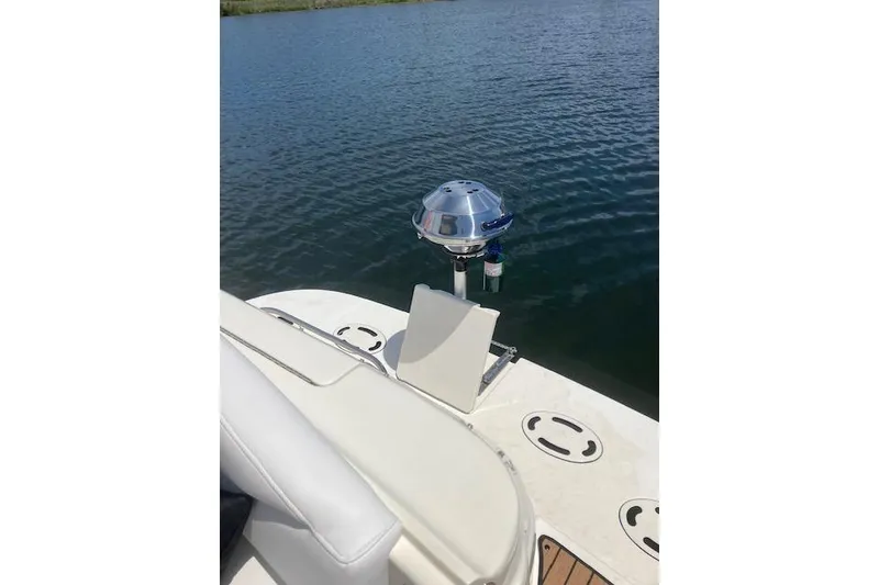 Slide: The Image of 2001 Sea Ray 380 Sundancer boat with a mounted grill on deck by the water. - 17