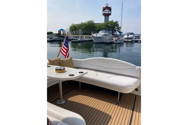 Slide: The Image of 2001 Sea Ray 380 Sundancer yacht interior with American flag, docked at marina. - 21