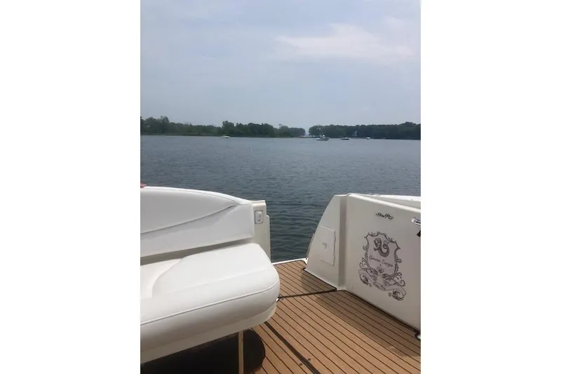 Slide: The Image of 2001 Sea Ray 380 Sundancer yacht on calm lake with scenic view. - 24