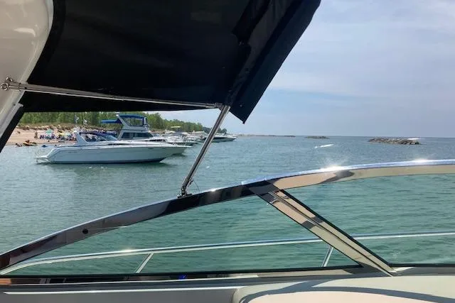 Slide: The Image of 2001 Sea Ray 380 Sundancer on tranquil waters near a sandy beach. - 29