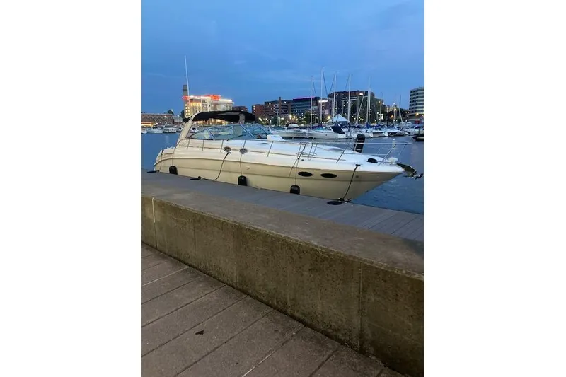 Slide: The Image of 2001 Sea Ray 380 Sundancer yacht docked at a marina during twilight. - 32
