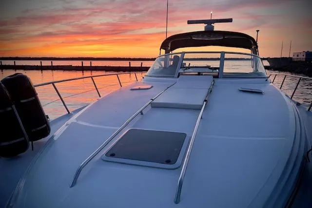 Slide: The Image of 2001 Sea Ray 380 Sundancer yacht at sunset, docked by calm waters. - 33