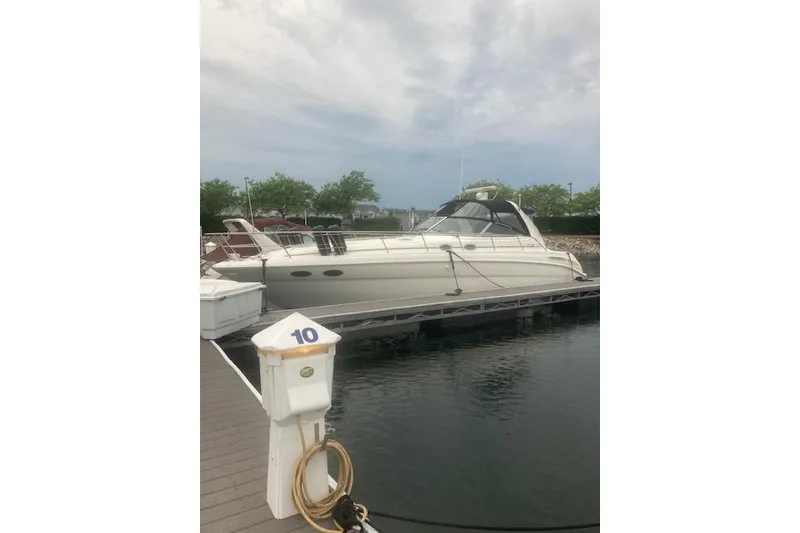 Slide: The Image of 2001 Sea Ray 380 Sundancer yacht docked at marina, cloudy sky background. - 38