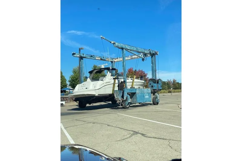 Slide: The Image of 2001 Sea Ray 380 Sundancer yacht on a boat lift in a parking lot. - 41