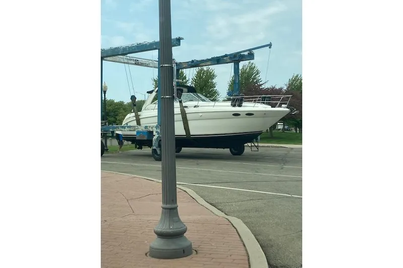 Slide: The Image of 2001 Sea Ray 380 Sundancer yacht on a lift, parked on a paved area. - 42