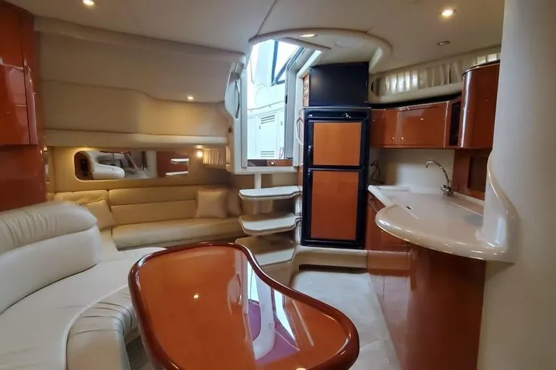 Slide: The Image of Luxurious interior of 2001 Sea Ray 380 Sundancer yacht with elegant seating and kitchenette. - 5