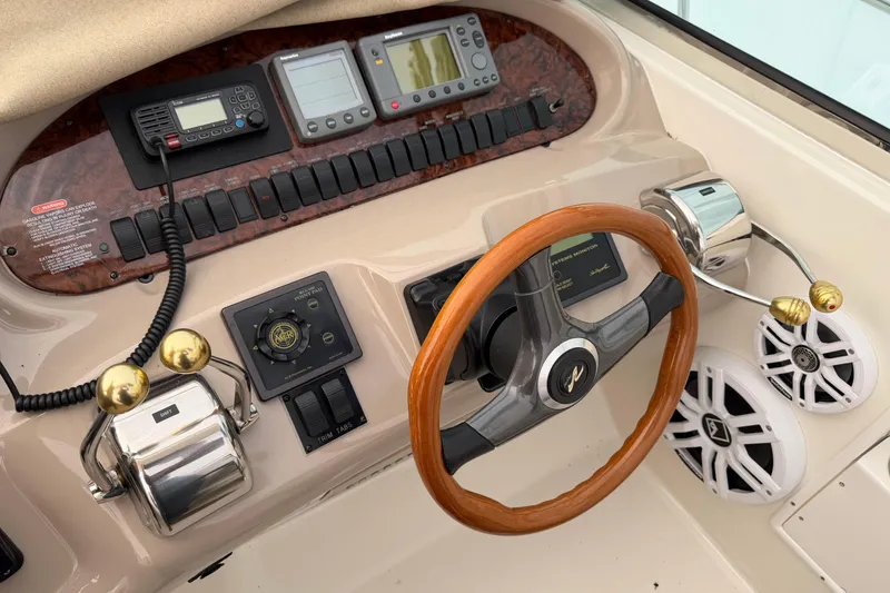 Slide: The Image of 2001 Sea Ray 380 Sundancer helm with wood steering wheel and control panel. - 8