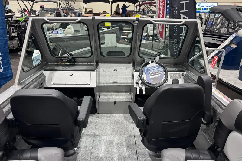 Slide: The Image of 2026 Crestliner 2050 Commander boat interior with steering wheel and seating. - 3