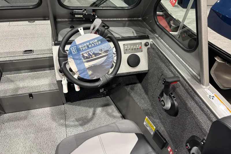 Slide: The Image of 2026 Crestliner 2050 Commander boat interior with steering wheel and control panel. - 4