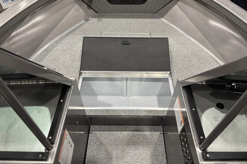 Slide: The Image of 2026 Crestliner 2050 Commander boat interior with open storage compartment. - 7