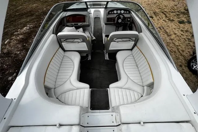 Slide: The Image of Interior of a 2002 Cobalt 262 boat with white leather seating and dashboard. - 14