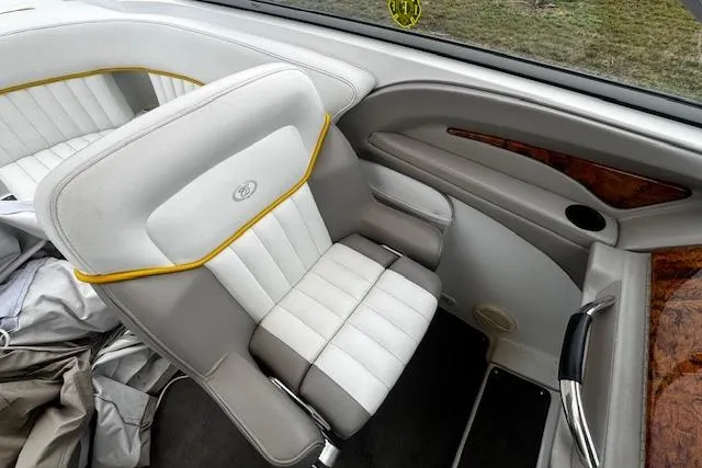 Slide: The Image of 2002 Cobalt 262 boat interior with white leather seating and wood accents. - 15