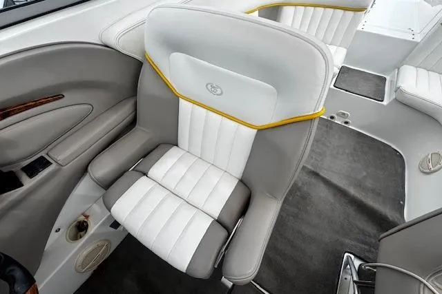 Slide: The Image of Luxury seating in a 2002 Cobalt 262 boat, featuring white and gray upholstery. - 16