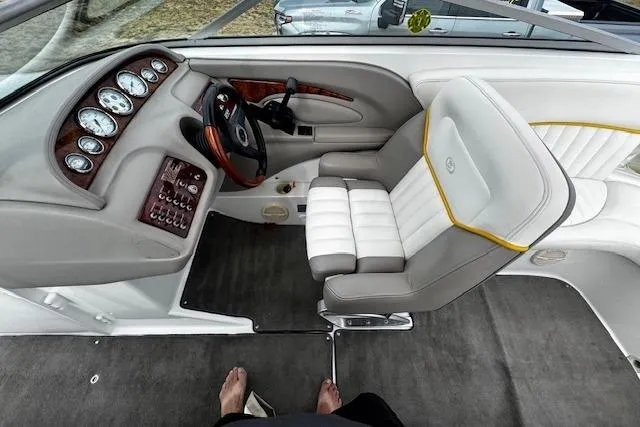 Slide: The Image of Interior of a 2002 Cobalt 262 boat with plush seating and control panel. - 18