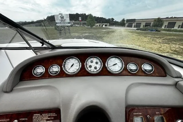 Slide: The Image of Dashboard of a 2002 Cobalt 262 boat with multiple gauges and wood trim. - 19