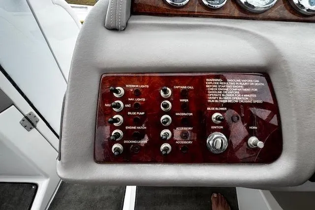 Slide: The Image of Control panel of a 2002 Cobalt 262 boat with various switches and warning label. - 20