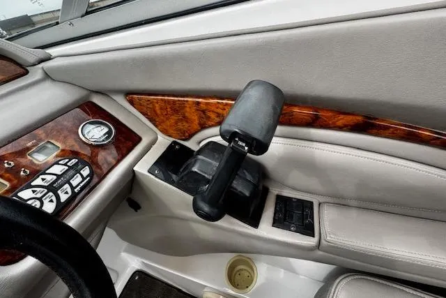 Slide: The Image of Interior of a 2002 Cobalt 262 boat with control panel and throttle lever. - 21