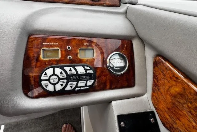 Slide: The Image of Control panel of a 2002 Cobalt 262 boat with wood finish and Sony audio system. - 22