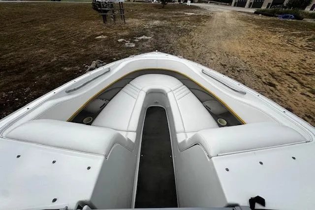 Slide: The Image of 2002 Cobalt 262 boat interior with white seating and open bow design. - 24