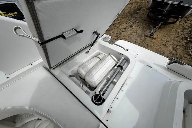 Slide: The Image of Open storage compartment on 2002 Cobalt 262 boat with fenders and equipment. - 26