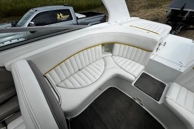 Slide: The Image of 2002 Cobalt 262 boat interior with white leather seating and yellow accents. - 29