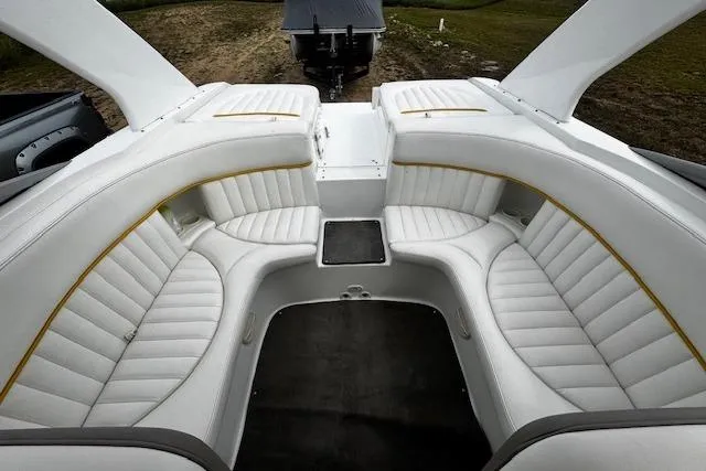 Slide: The Image of 2002 Cobalt 262 boat interior with white leather seating and sleek design. - 30