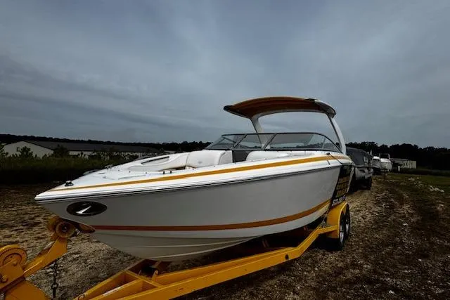 Slide: The Image of 2002 Cobalt 262 boat on a yellow trailer under cloudy skies. - 5