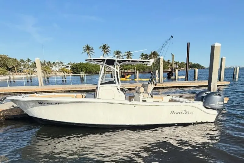 The Image of 2016 NauticStar 25 XS boat on trailer under blue sky. - 0