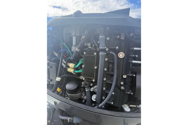 Slide: The Image of 2016 NauticStar 25 XS boat on trailer under sunny sky. - 11