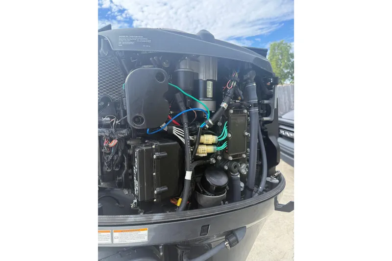 Slide: The Image of 2016 NauticStar 25 XS boat on trailer under sunny sky. - 12