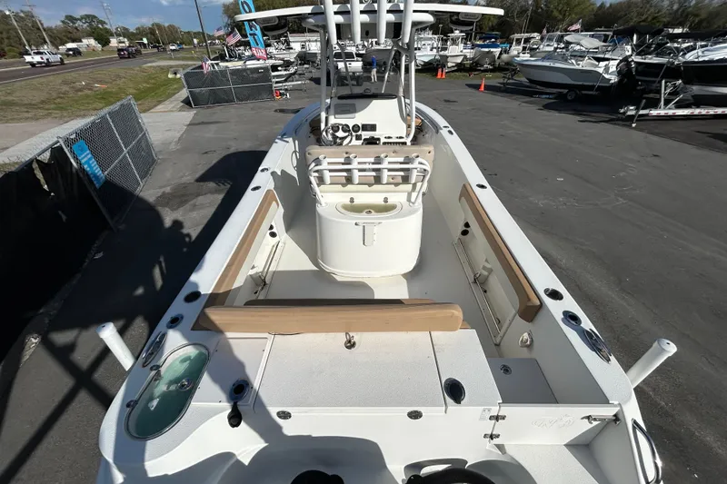 Slide: The Image of 2016 NauticStar 25 XS boat interior with seating and console, parked in a marina. - 14