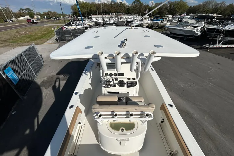 Slide: The Image of 2016 NauticStar 25 XS boat with center console and rod holders, docked at a marina. - 17