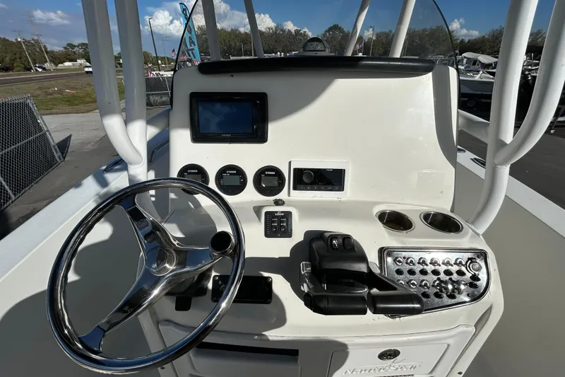 Slide: The Image of 2016 NauticStar 25 XS boat dashboard with steering wheel and control panel. - 20