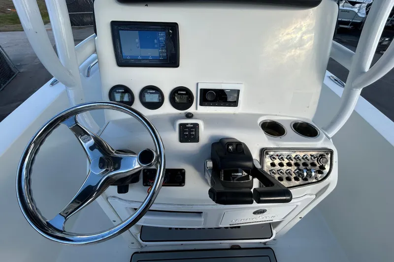 Slide: The Image of 2016 NauticStar 25 XS boat console with steering wheel, gauges, and controls. - 21