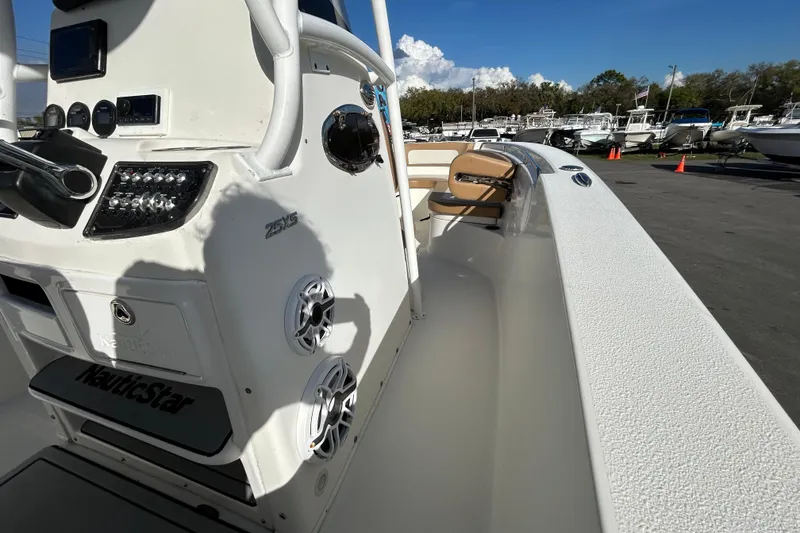 Slide: The Image of 2016 NauticStar 25 XS boat interior with control panel and seating. - 24