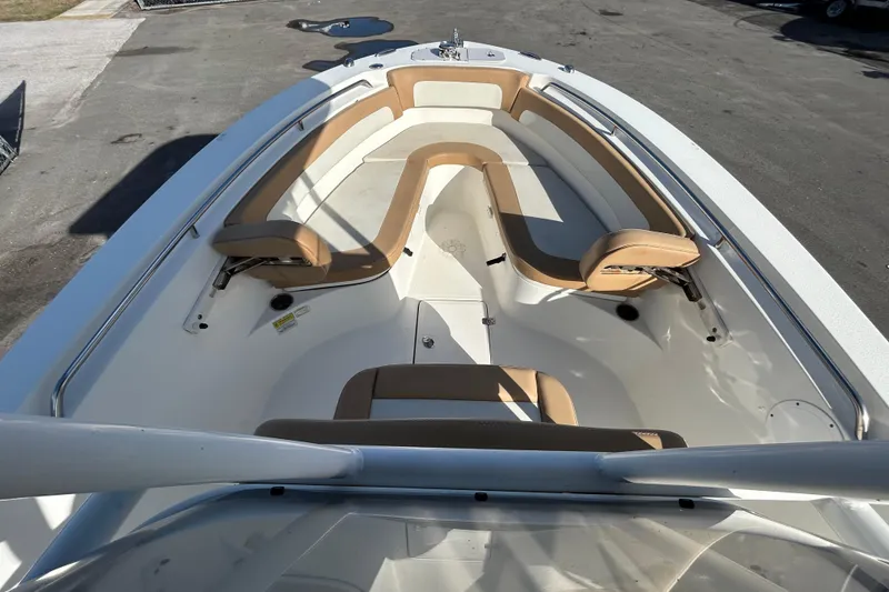 Slide: The Image of 2016 NauticStar 25 XS boat interior with tan seating and spacious layout. - 26
