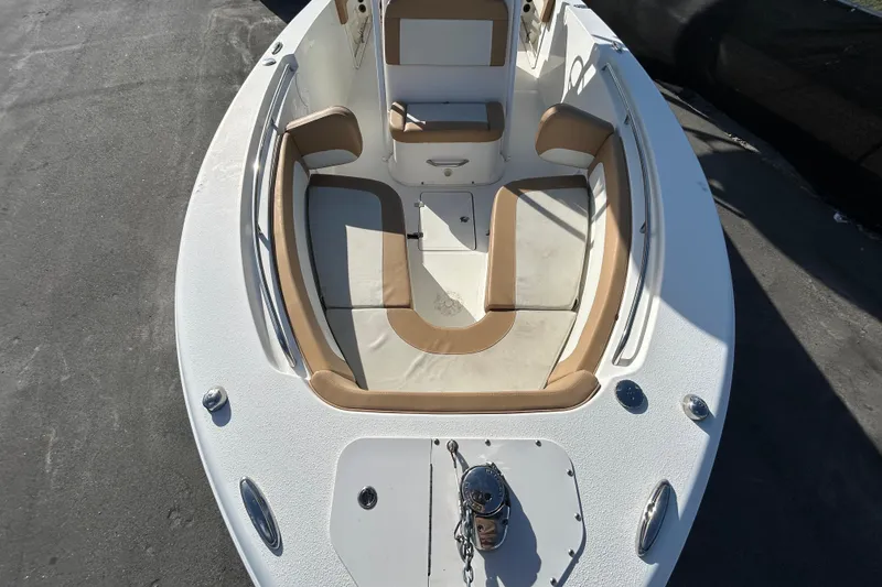 Slide: The Image of 2016 NauticStar 25 XS boat interior with tan seating and anchor storage. - 29