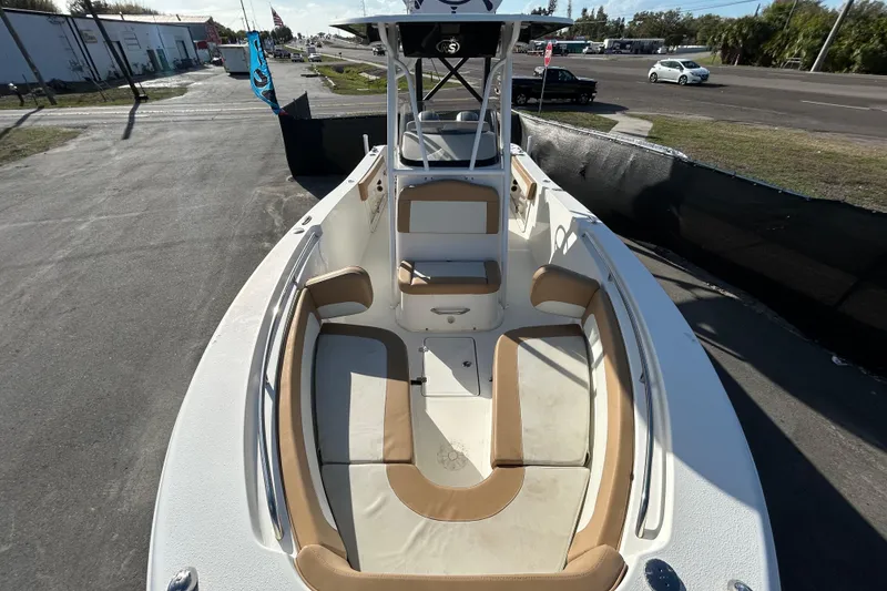 Slide: The Image of 2016 NauticStar 25 XS boat with tan seating, parked on a sunny day. - 30