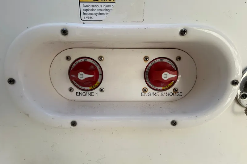 Slide: The Image of Battery switches on a 2016 NauticStar 25 XS boat, labeled Engine 1 and Engine 2/House. - 48