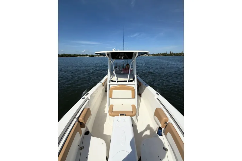Slide: The Image of 2016 NauticStar 25 XS boat with dual outboard motors, docked on a sunny day. - 5