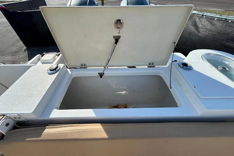 Slide: The Image of Open storage compartment on a 2016 NauticStar 25 XS boat, showcasing interior space. - 55