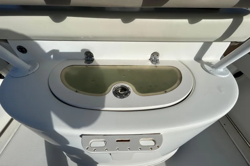 Slide: The Image of 2016 NauticStar 25 XS boat livewell with white seating and stainless steel fixtures. - 60