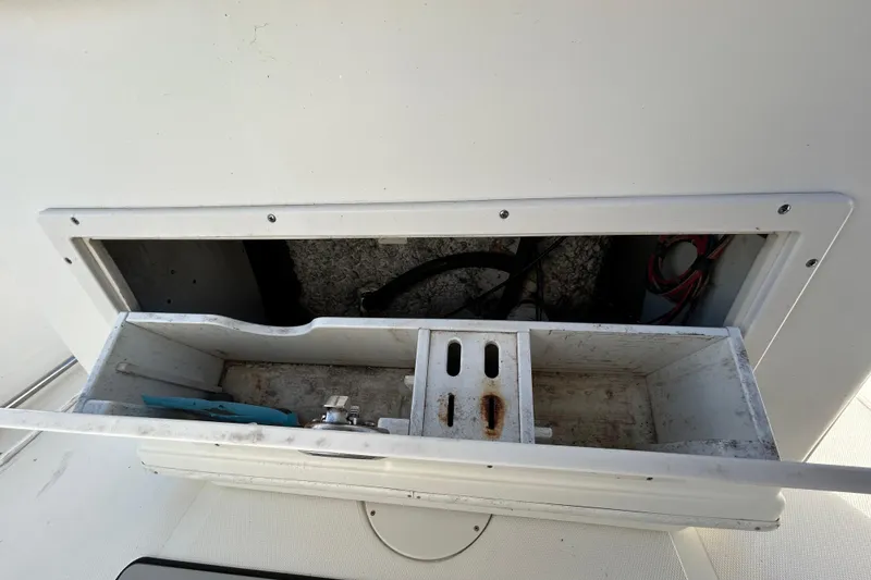 Slide: The Image of Open storage compartment on 2016 NauticStar 25 XS boat, showing interior details. - 68