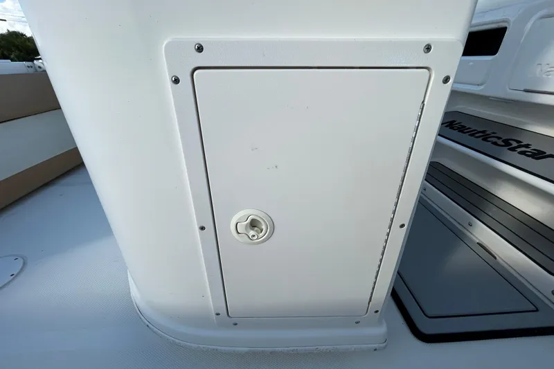 Slide: The Image of 2016 NauticStar 25 XS boat storage compartment and deck view. - 70