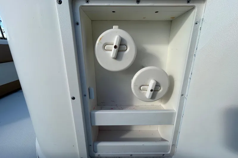 Slide: The Image of 2016 NauticStar 25 XS boat compartment with two white access hatches. - 72
