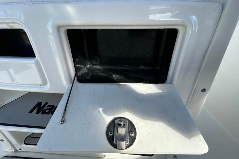Slide: The Image of Open storage compartment on a 2016 NauticStar 25 XS boat. - 76