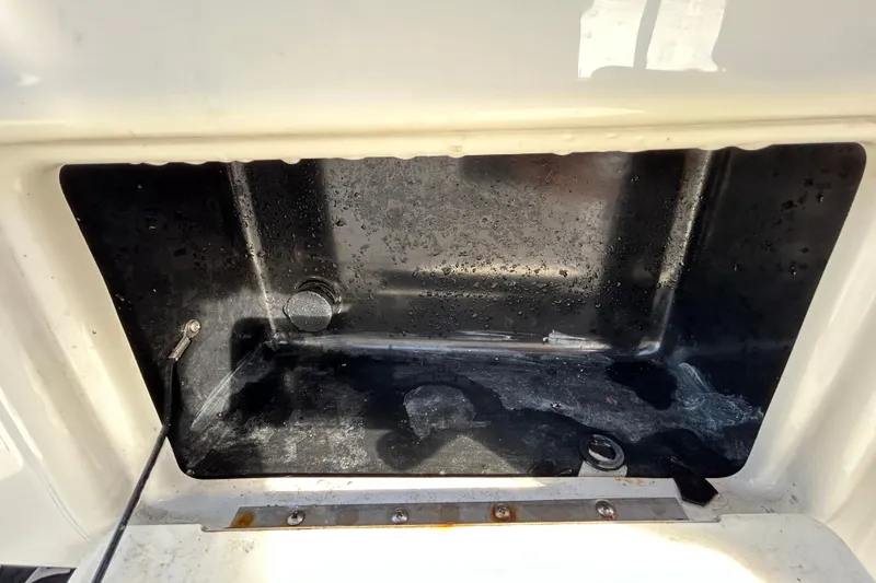 Slide: The Image of Storage compartment of a 2016 NauticStar 25 XS boat, showing interior details. - 77