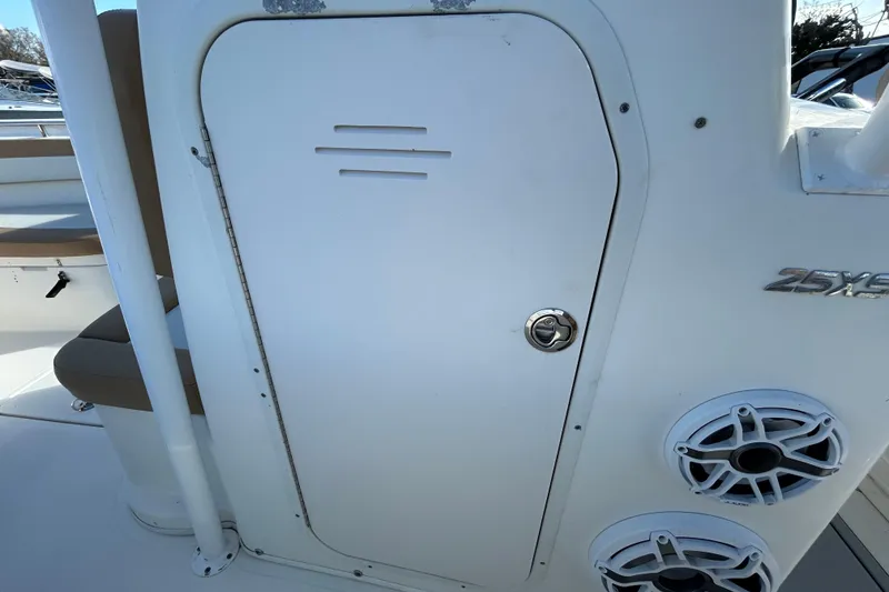 Slide: The Image of 2016 NauticStar 25 XS boat console with speakers and storage compartment. - 78