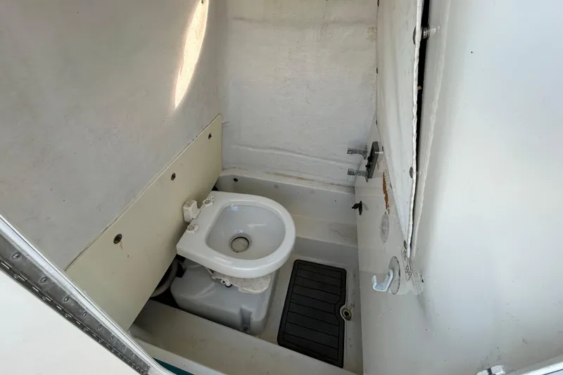 Slide: The Image of 2016 NauticStar 25 XS boat interior with compact marine toilet. - 80
