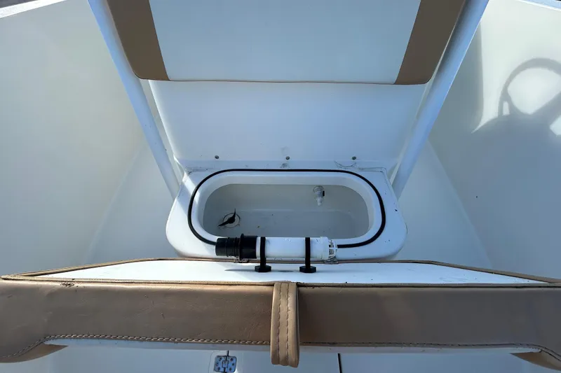 Slide: The Image of 2016 NauticStar 25 XS boat interior with open storage compartment. - 82